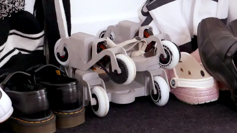 A pair of prototypes of the KoumKoum, among shoes, showing how compact it is