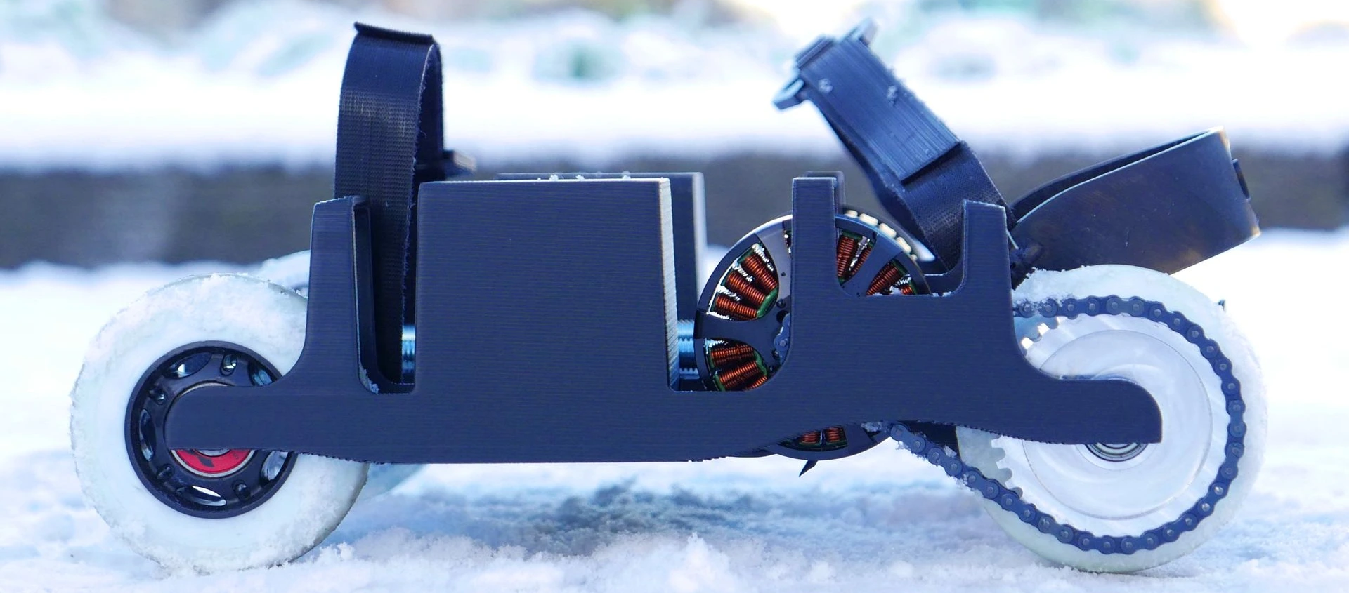 Closeup, from the side, of the KoumKoum electric rollerskate, with new strapping system, in snowy Brussels